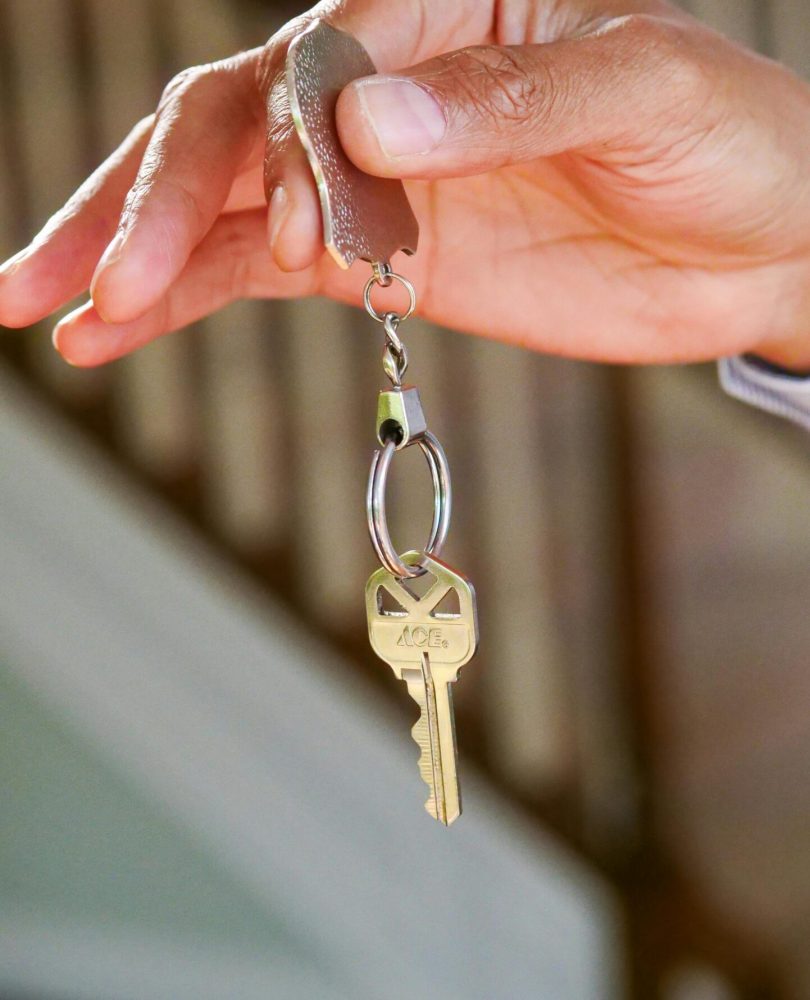 Close-up of a hand holding a key, symbolizing new homeownership or rental.