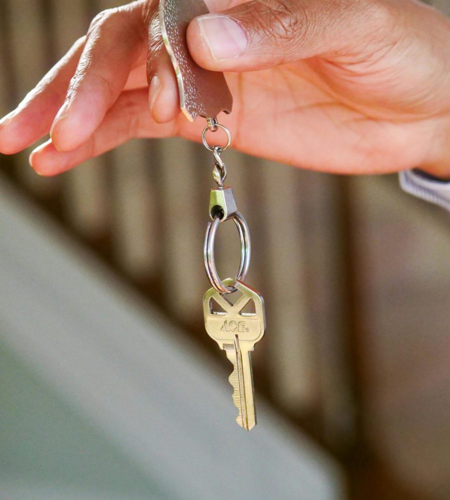 Close-up of a hand holding a key, symbolizing new homeownership or rental.